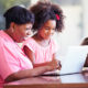 woman and little girl smiling at laptop