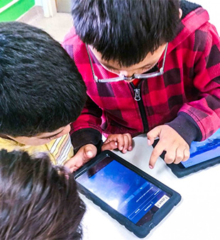 kids playing with Telmate tablets