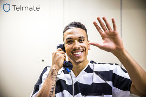 Inmate-on-phone_waving_HiPass_TelmateLogo
