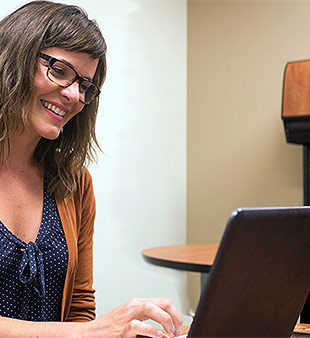 woman smiling at laptop