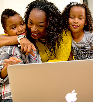 woman with children video visiting on laptop