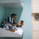 inmate lying on bunk using tablet