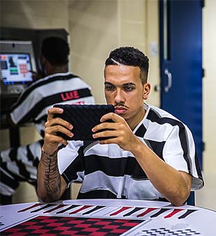 inmate with tablet