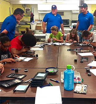 Volunteers Get Kids to Take Apart Tablets